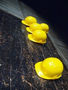 yellow hardhats on a table