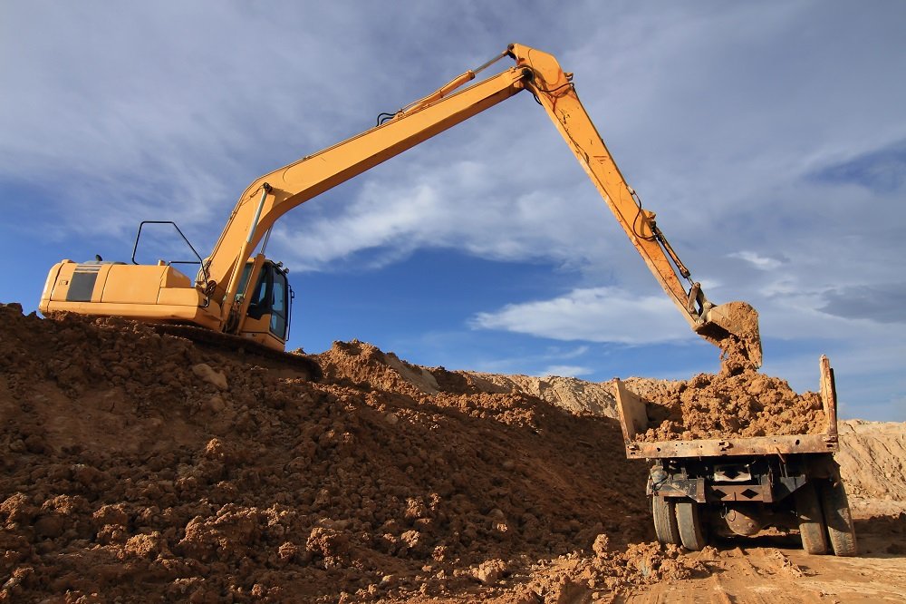 excavator loading a rock truck