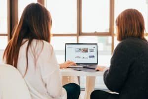 two ladies entering data into system